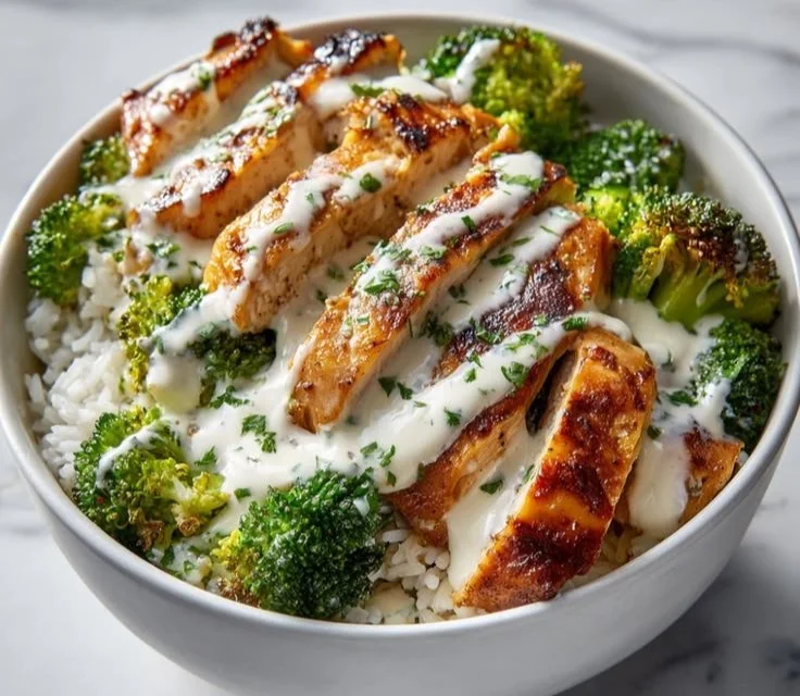 Chicken and broccoli bowls topped with creamy garlic sauce