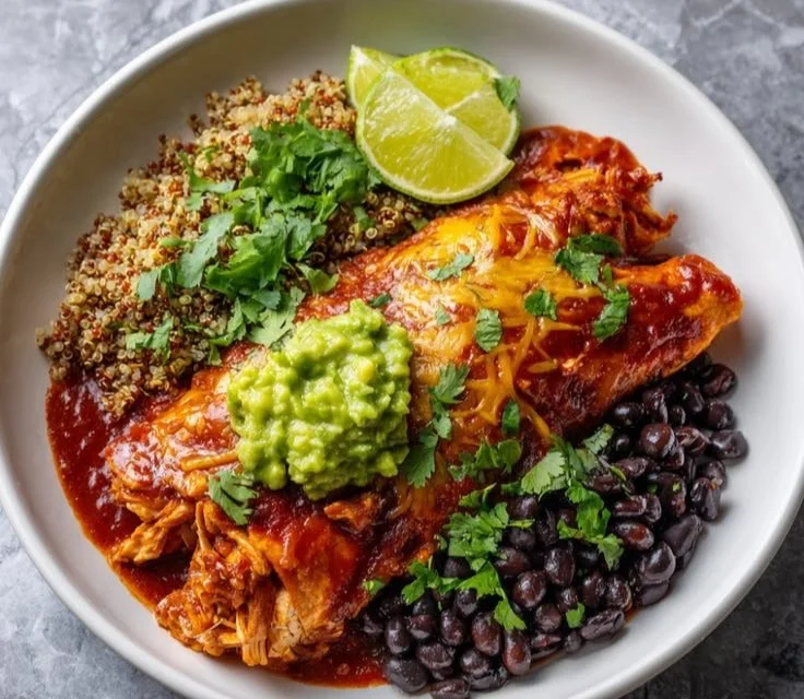 High protein chicken enchilada bowls topped with cheese and fresh herbs.