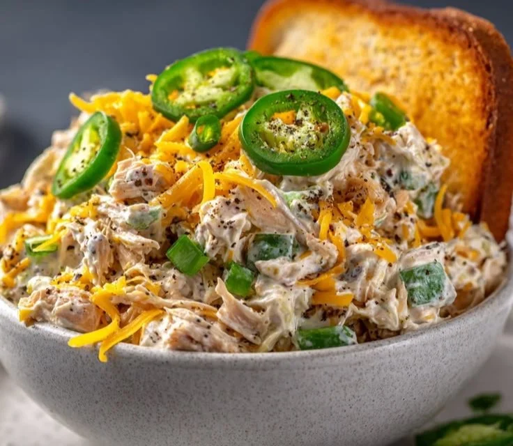Jalapeno Popper Chicken Salad served in a bowl garnished with jalapenos and herbs