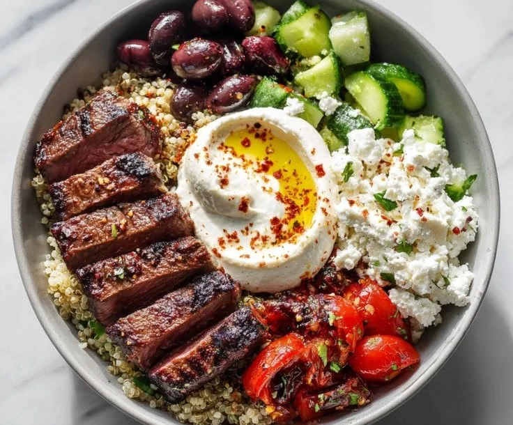 Mediterranean steak bowl with grilled steak and fresh vegetables