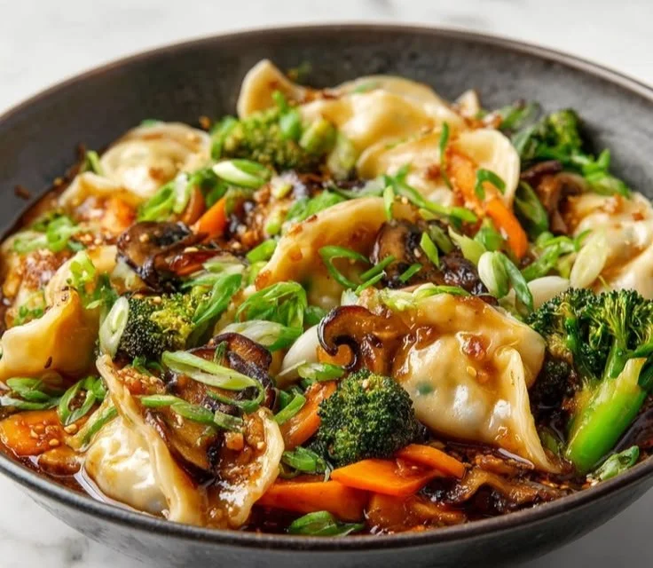 Colorful potsticker stir fry with vegetables in a skillet
