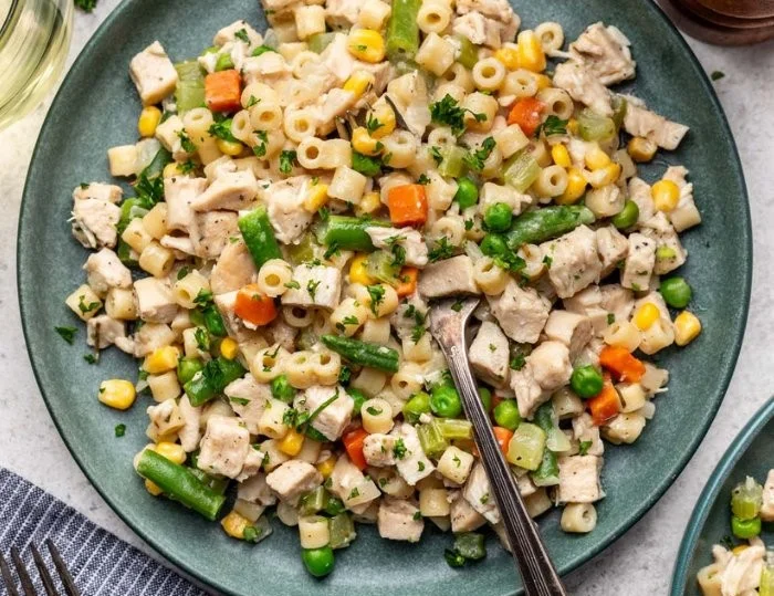 One-skillet chicken pot pie noodle skillet ready to serve, filled with chicken and veggies.