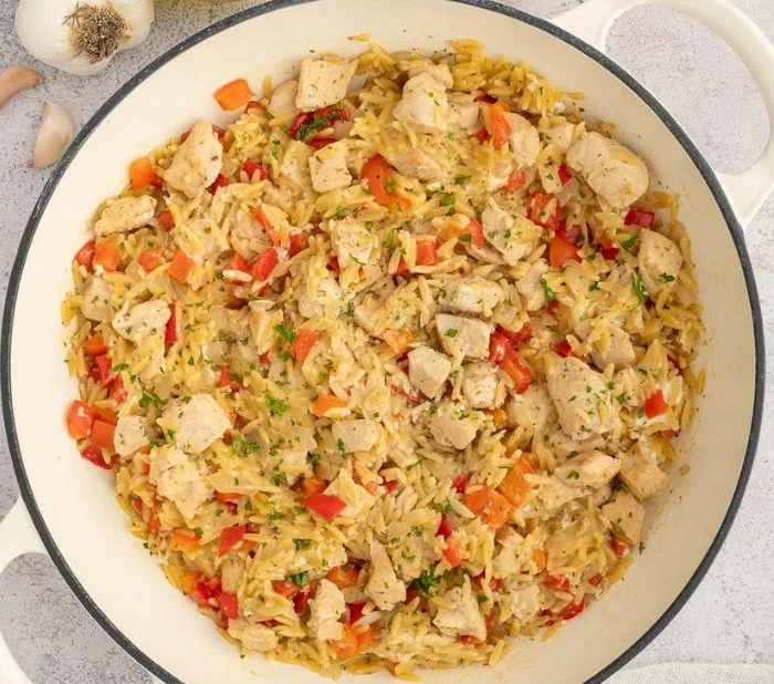 Creamy chicken orzo dish in a cozy bowl for a one-pot dinner.
