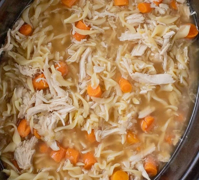 Delicious Crockpot Chicken Noodle Soup garnished with herbs in a bowl.