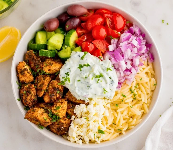 High-protein chicken gyro bowls served with fresh vegetables and sauce for a healthy meal
