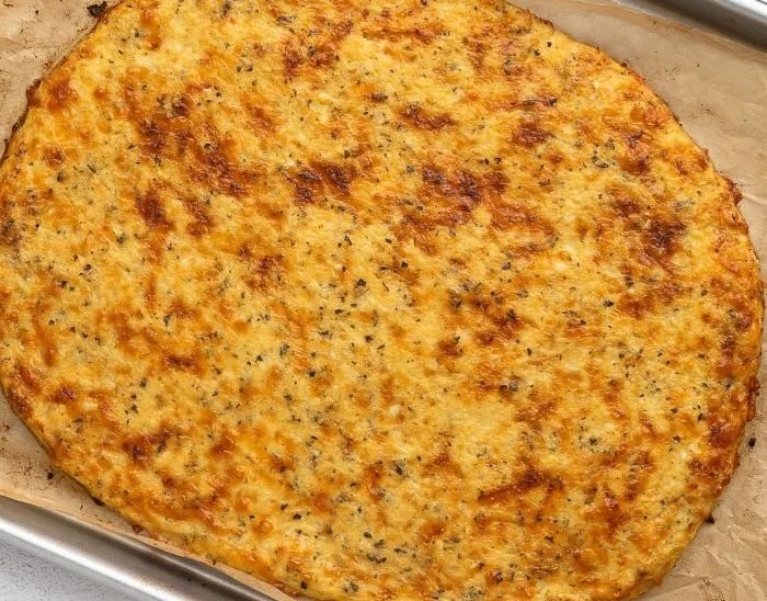 Gluten free and low carb cauliflower pizza crust topped with fresh ingredients.