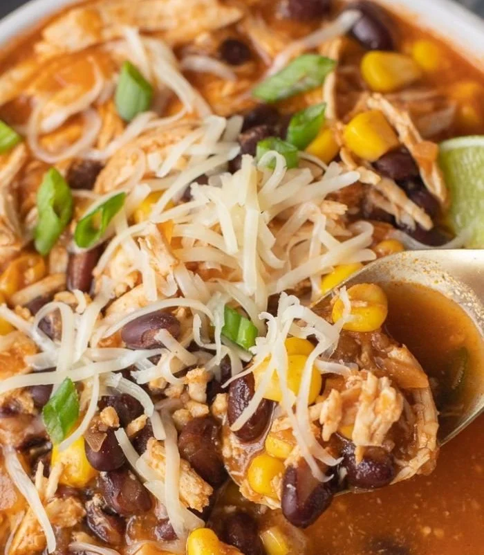 High protein chicken taco soup bowl garnished with cilantro and lime