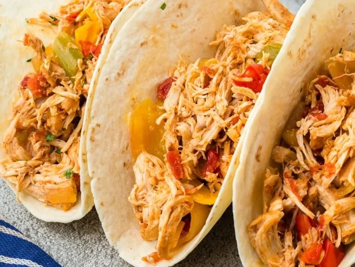 High protein crockpot chicken fajitas served with colorful peppers and onions