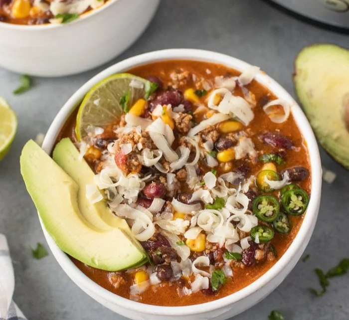 High protein taco soup bowl filled with beans, meat, and spices.