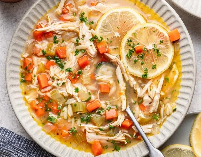 Bowl of flavorful lemon chicken soup garnished with fresh herbs