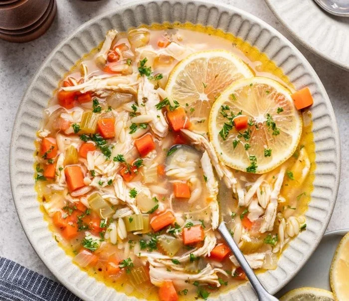 Delicious bowl of Lemon Chicken Soup garnished with fresh herbs