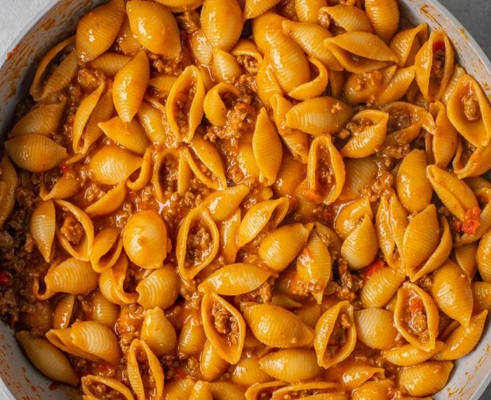 Delicious one pot taco pasta with vibrant colors and toppings in a skillet