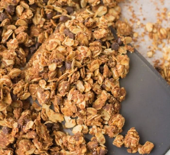 Bowl of peanut butter granola with nuts and dried fruit for a healthy breakfast