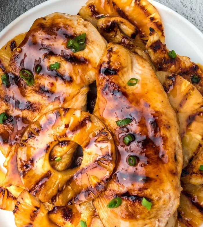 Healthy summer Pineapple Chicken Skewers on a grill plate.