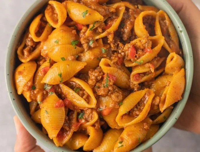 Delicious protein-packed taco pasta with vibrant toppings in a bowl
