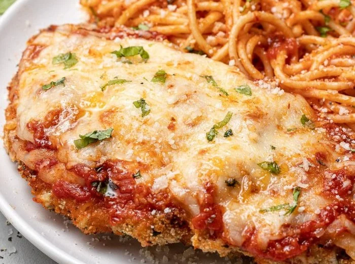 High protein chicken parmesan dish topped with marinara and cheese.